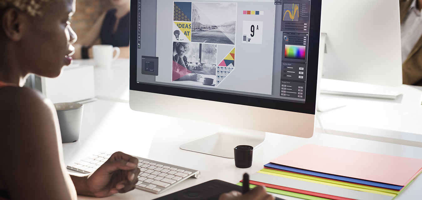 Graphic designer working on branding and layout design.